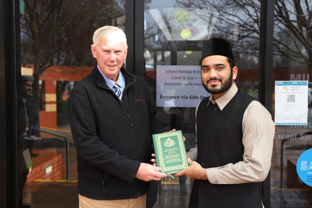 Murabi Sahib presenting Holy Quran Honourable Mayor Des Noll