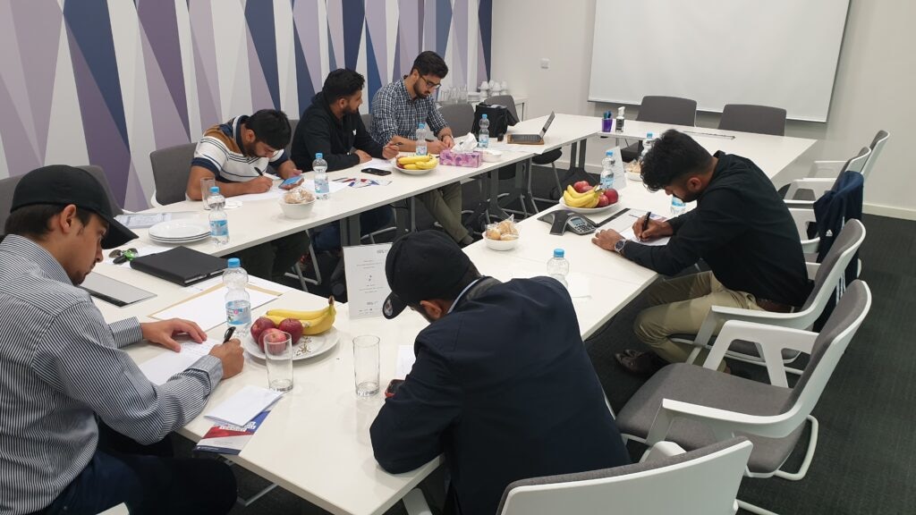 Khuddam writing letter to Huzur e Anwar atba