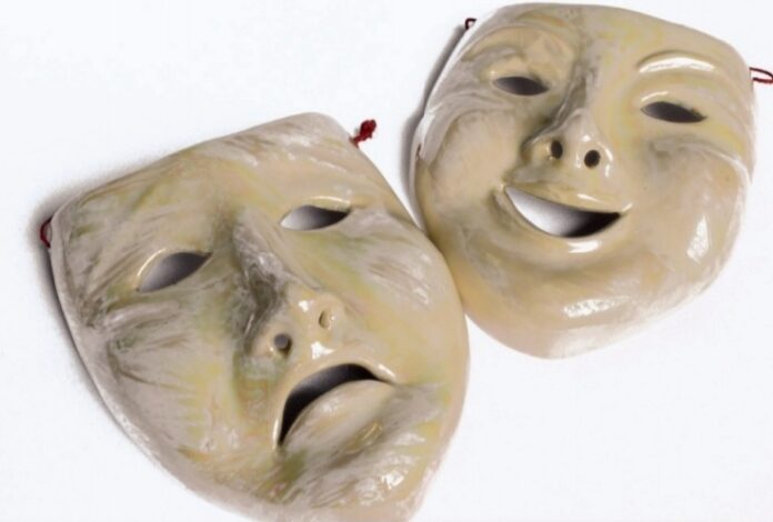 Two theatrical masks depicting emotions.
